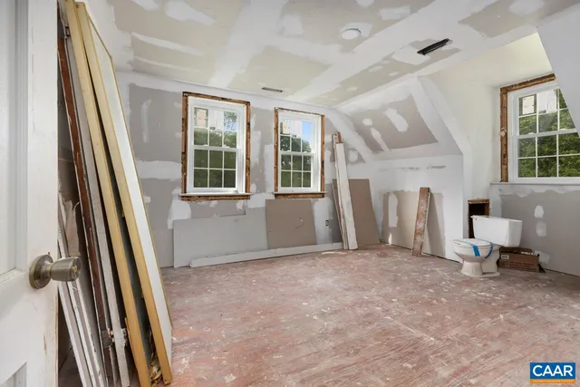 a view of a livingroom with wooden floor and stairs