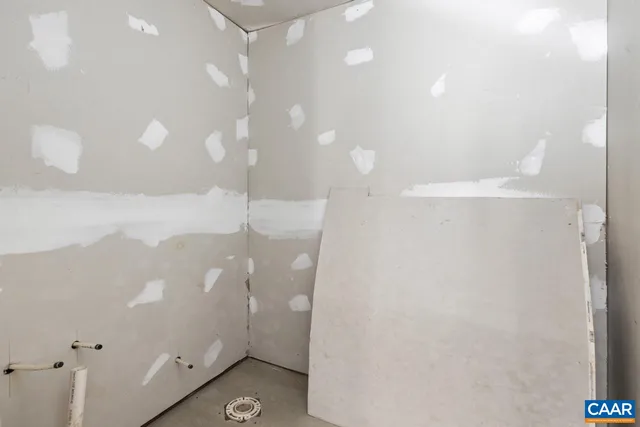 a view of a livingroom with entryway and a chandelier