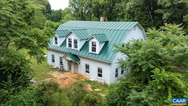 a view of a livingroom with furniture and stairs