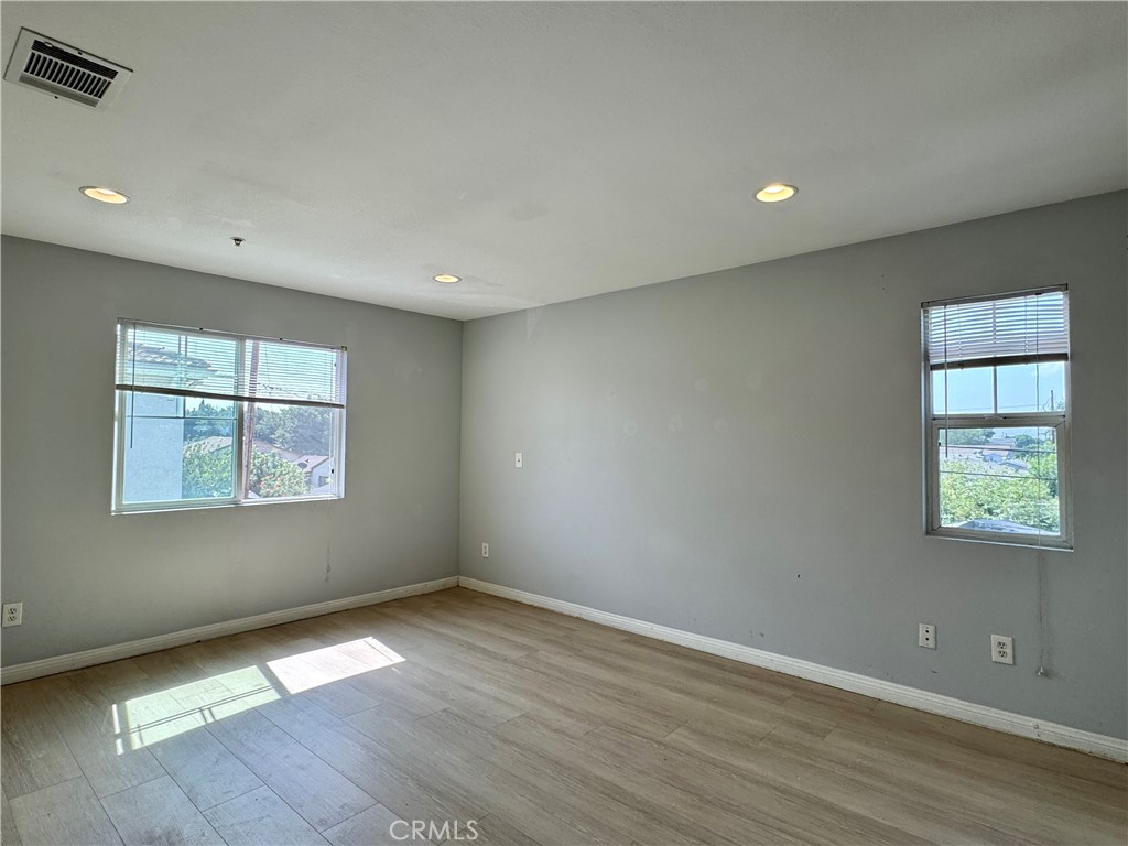 2840 Maxson Road El Monte, CA 91732 - Photo 7 of 20 an empty room with wooden floor and windows