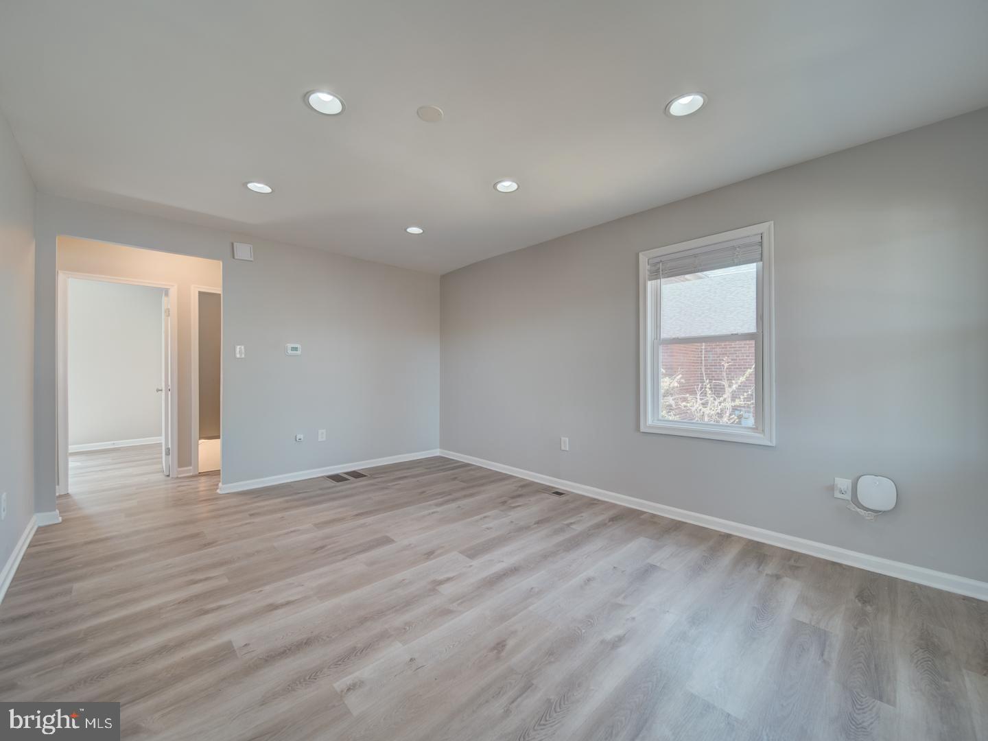 4217 Vine Street Capitol Heights, MD 20743 - Photo 13 of 60 a view of an empty room with wooden floor and a window