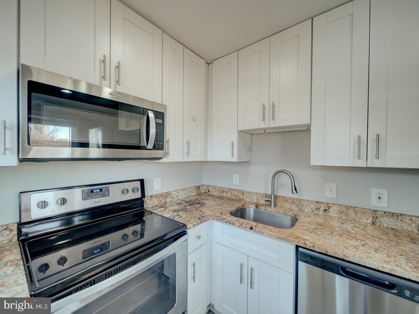 4217 Vine Street Capitol Heights, MD 20743 - Photo 24 of 60 a kitchen with appliances a sink and cabinets