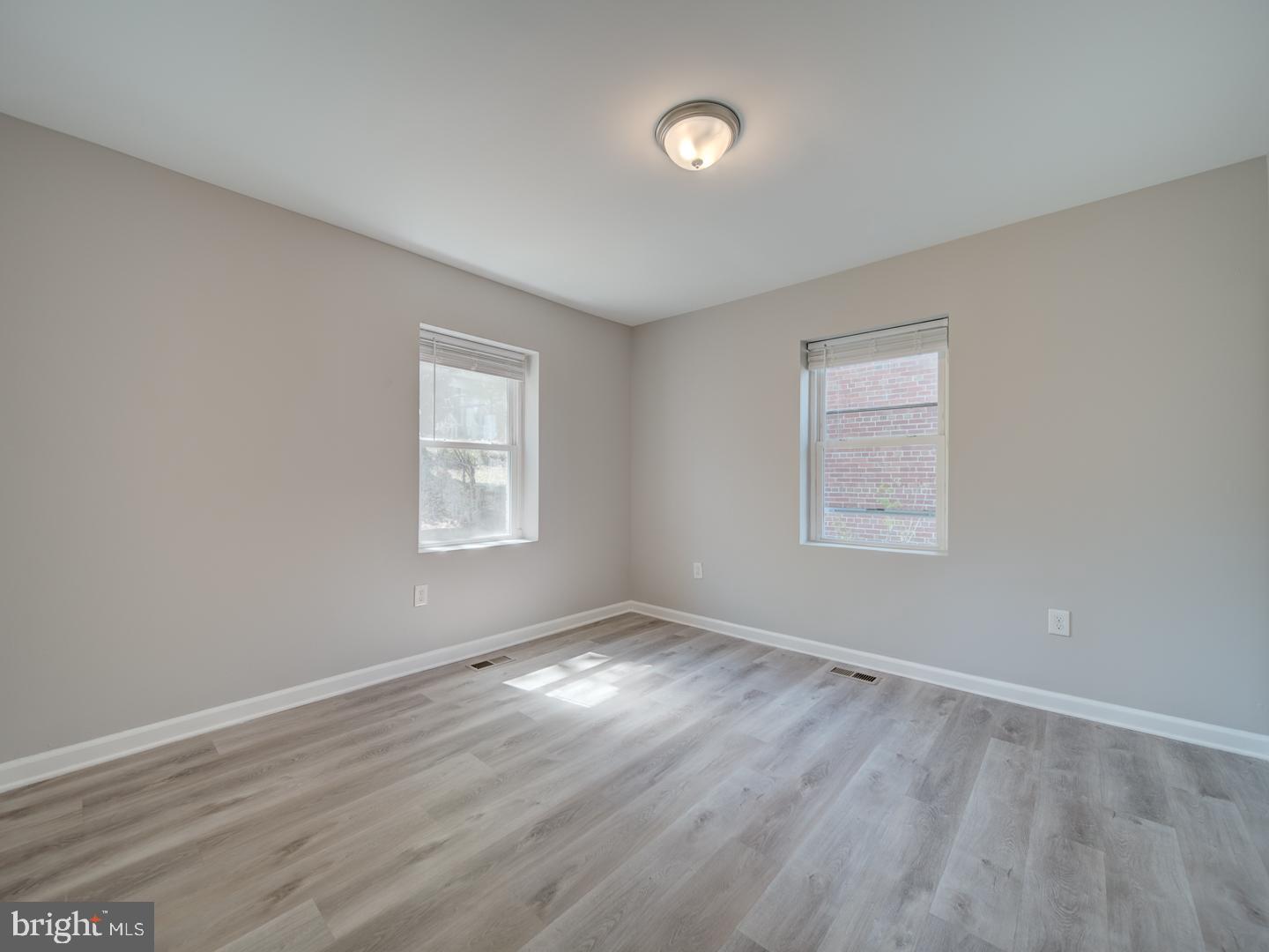 4217 Vine Street Capitol Heights, MD 20743 - Photo 32 of 60 an empty room with wooden floor and windows