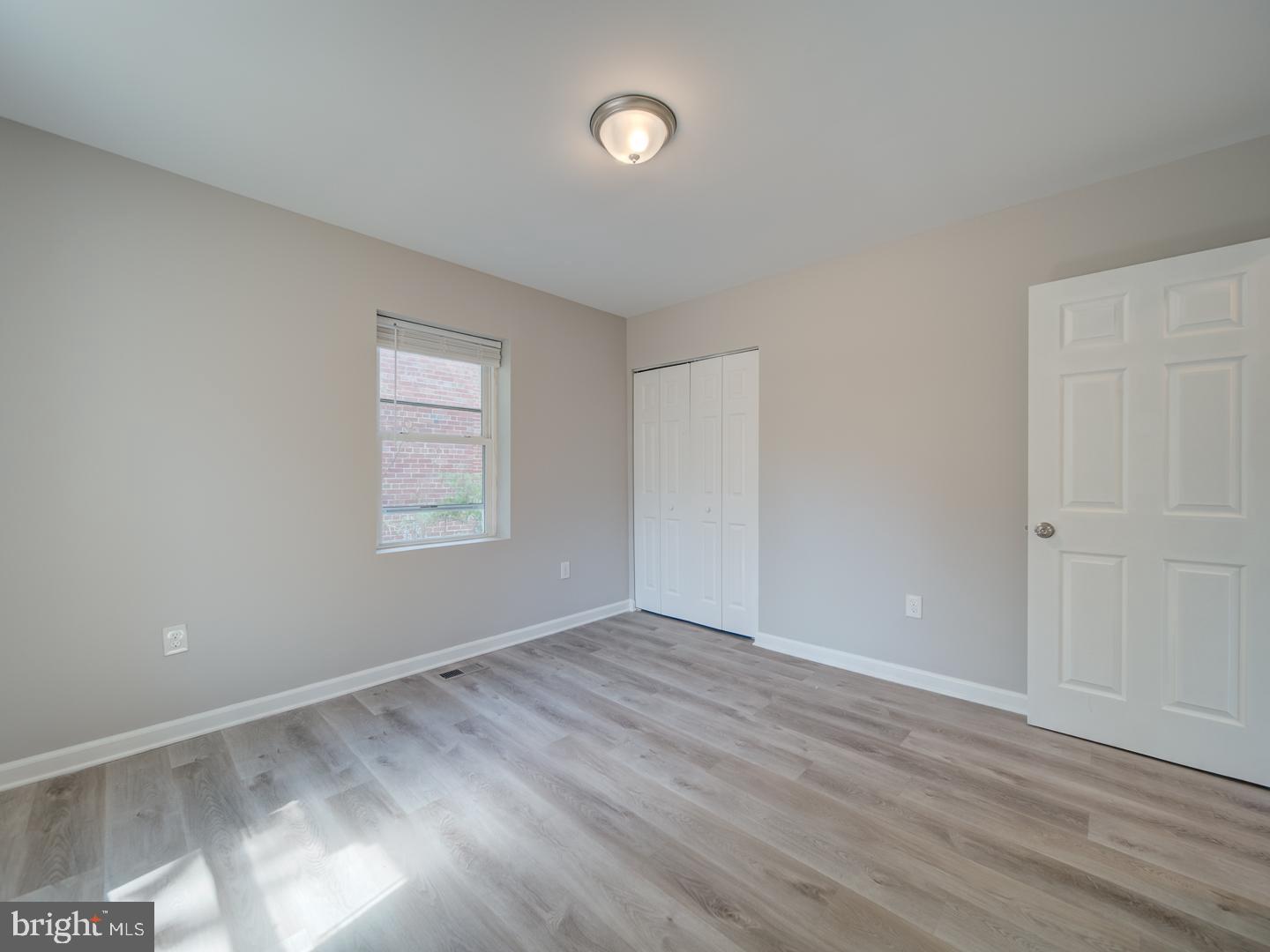 4217 Vine Street Capitol Heights, MD 20743 - Photo 33 of 60 a view of an empty room with wooden floor and a window
