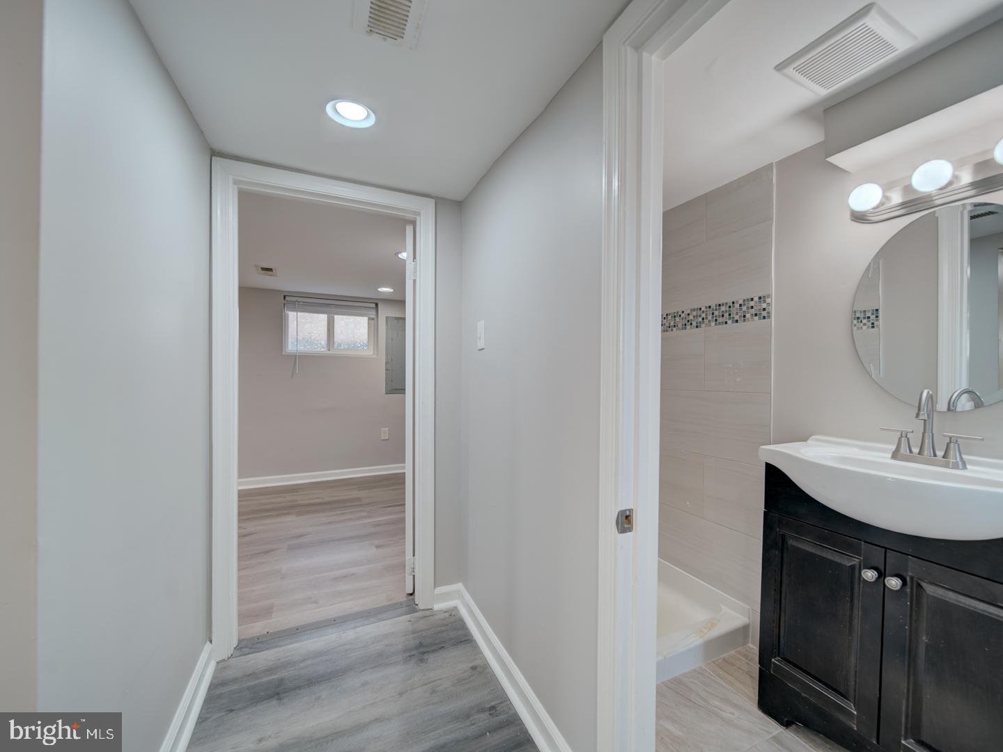 4217 Vine Street Capitol Heights, MD 20743 - Photo 42 of 60 a bathroom with a sink a light fixture and a mirror