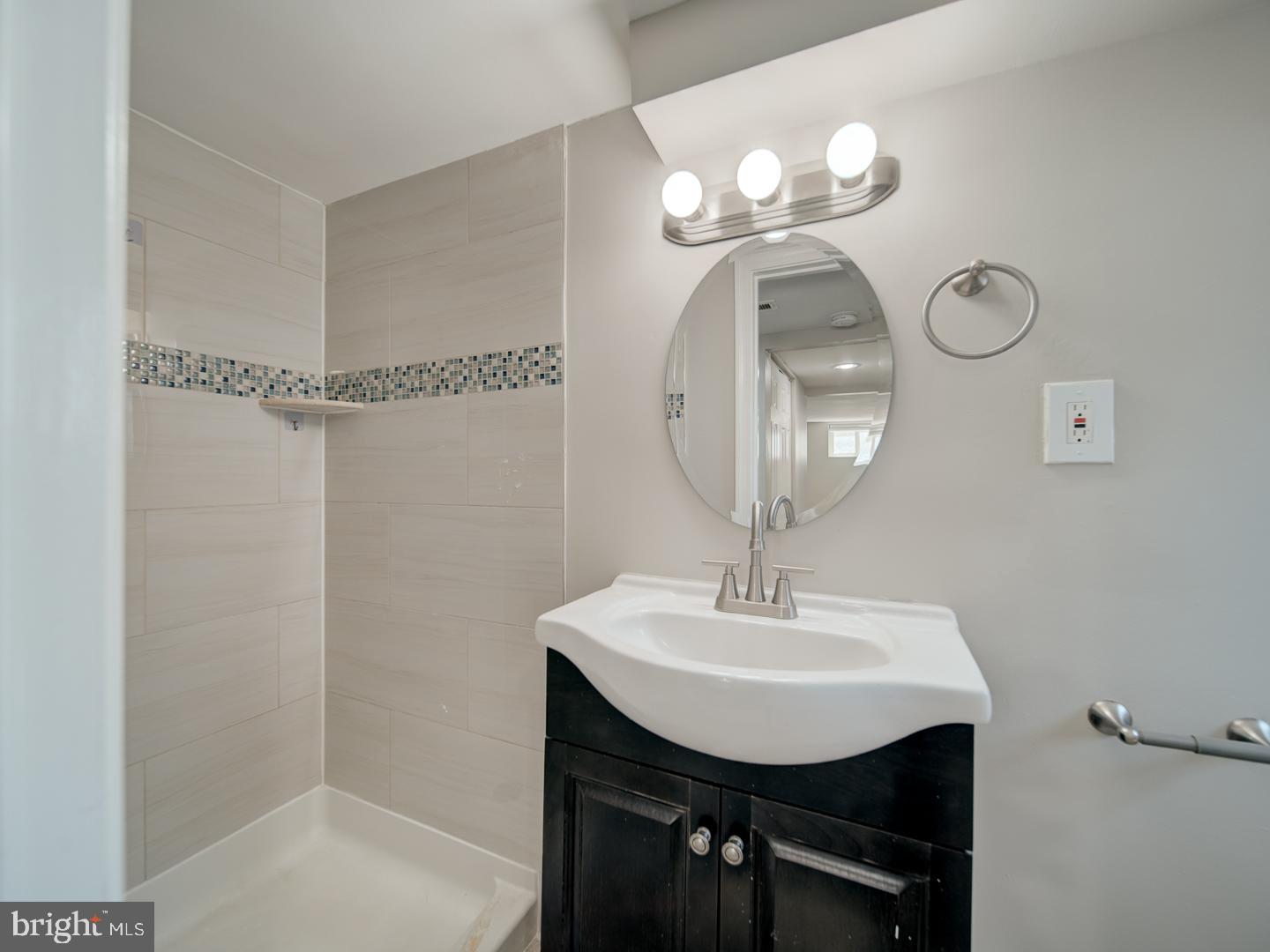 4217 Vine Street Capitol Heights, MD 20743 - Photo 43 of 60 a bathroom with a sink a mirror and a light fixture