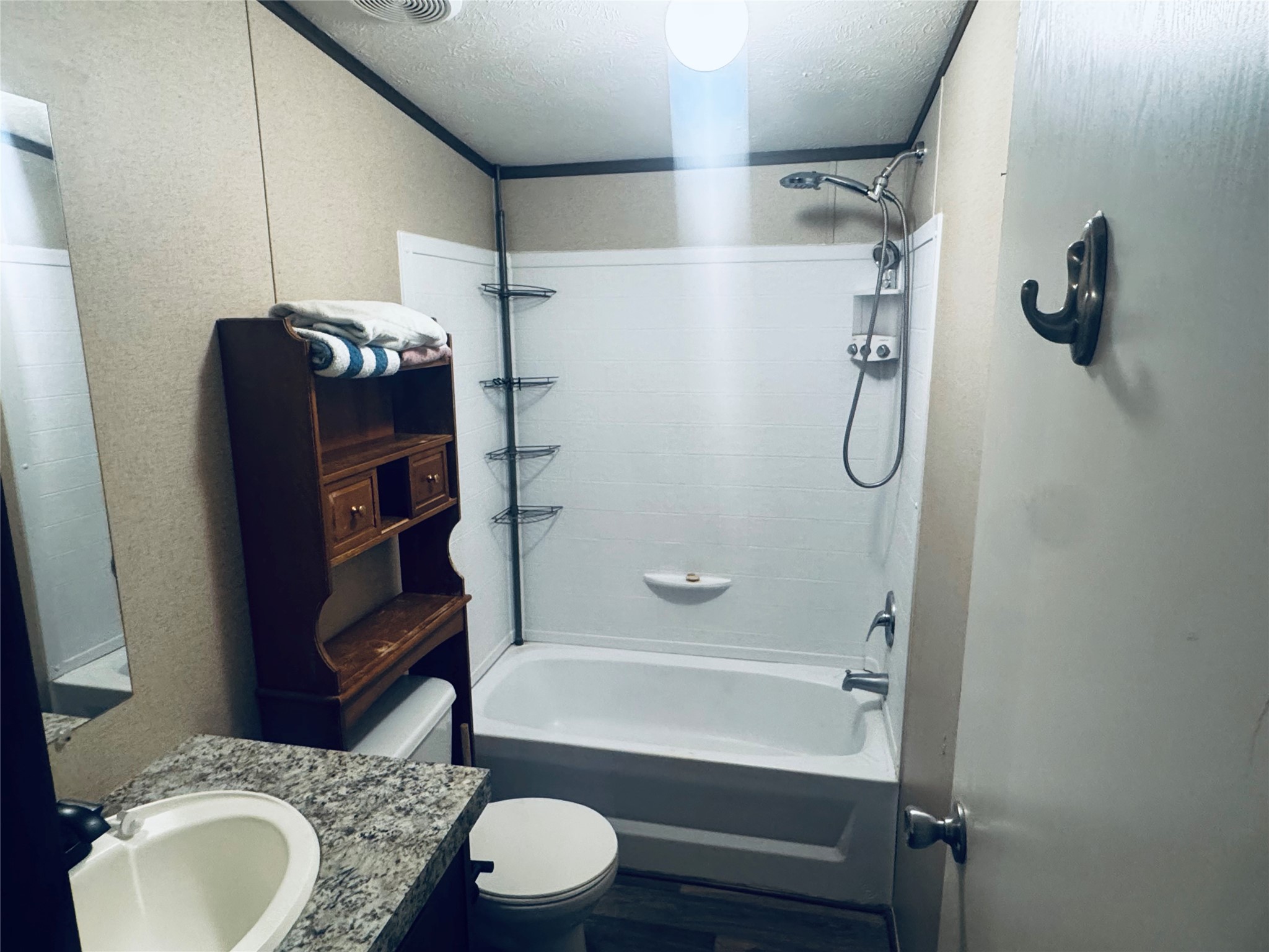 235 Red Oak Onalaska, TX 77360 - Photo 11 of 12 a bathroom with a granite countertop bathtub shower sink vanity and toilet