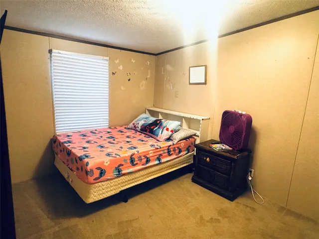 a bedroom with a bed and a chair