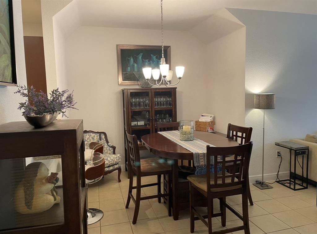 817 Southwest 147th Avenue, Unit 817 Pembroke Pines, FL 33027 - Photo 11 of 34 a view of a dining room with furniture and chandelier