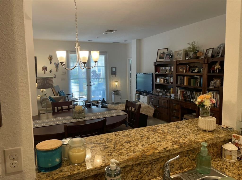 817 Southwest 147th Avenue, Unit 817 Pembroke Pines, FL 33027 - Photo 13 of 34 a large room with lots of clutter and furniture