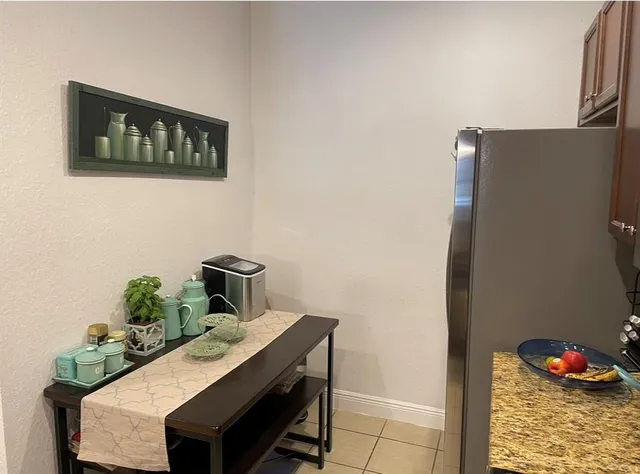a bathroom with a granite countertop sink vanity and mirror