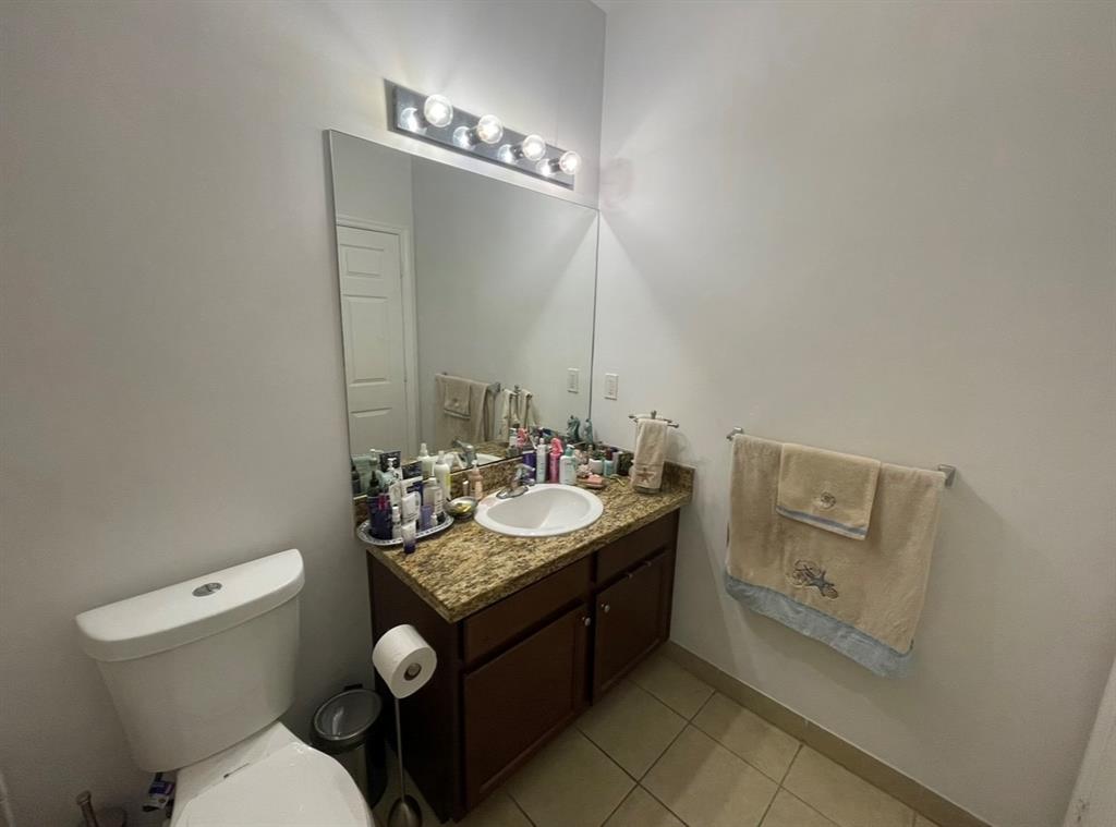 817 Southwest 147th Avenue, Unit 817 Pembroke Pines, FL 33027 - Photo 18 of 34 a bathroom with a toilet sink and mirror