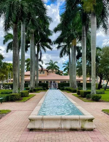 front view of house with a garden and trees