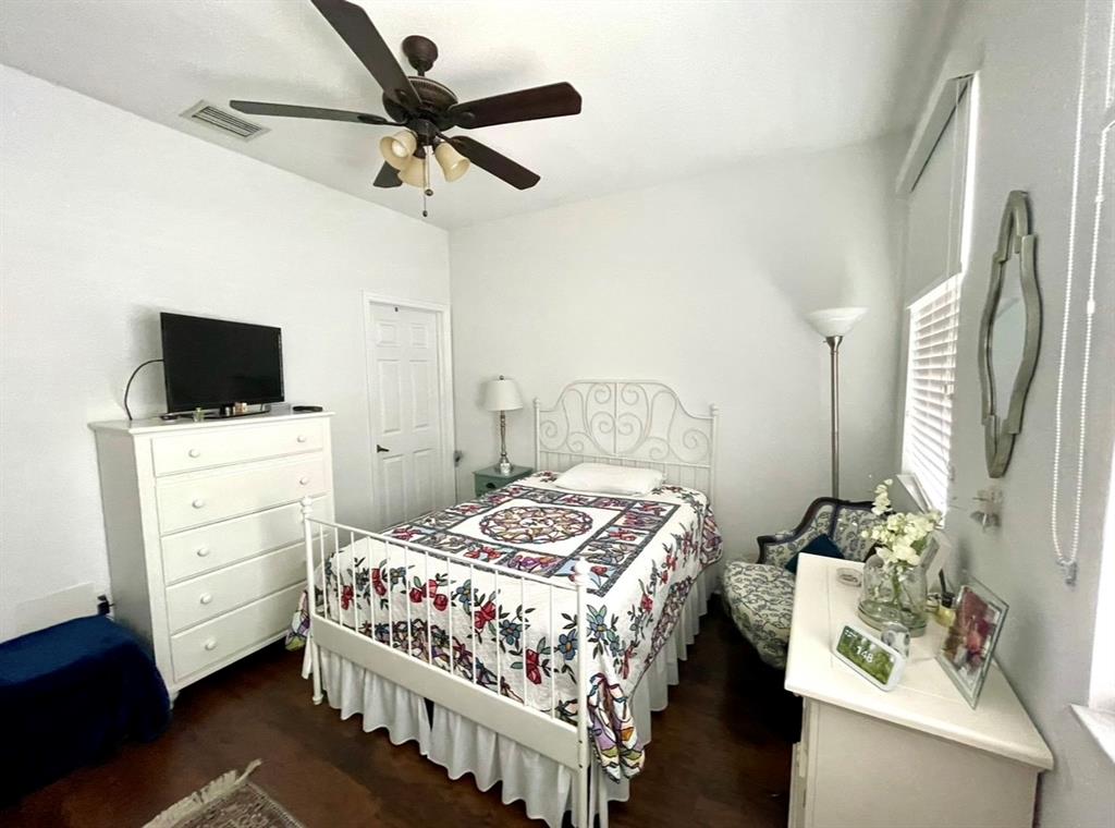817 Southwest 147th Avenue, Unit 817 Pembroke Pines, FL 33027 - Photo 23 of 34 a bedroom with a bed and a flat tv screen on the dresser