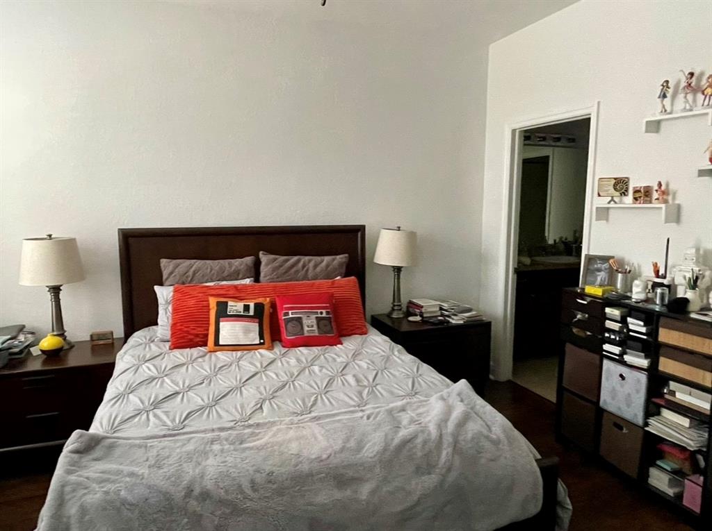 817 Southwest 147th Avenue, Unit 817 Pembroke Pines, FL 33027 - Photo 25 of 34 a bedroom with a bed and wooden floor