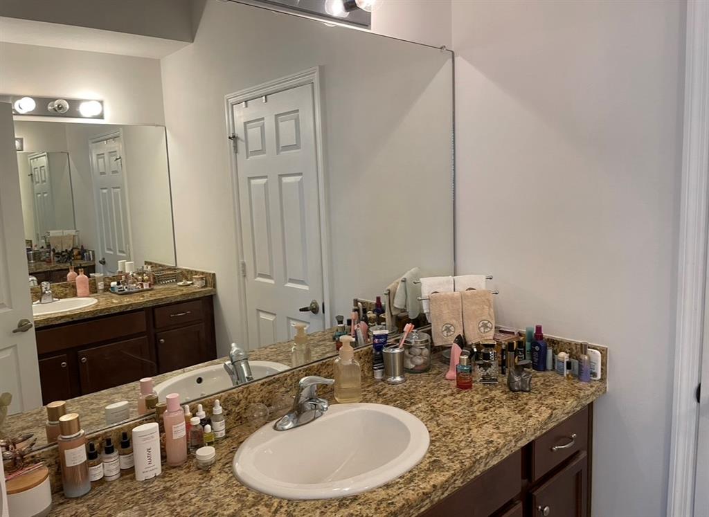 817 Southwest 147th Avenue, Unit 817 Pembroke Pines, FL 33027 - Photo 29 of 34 a bathroom with a granite countertop sink and a mirror