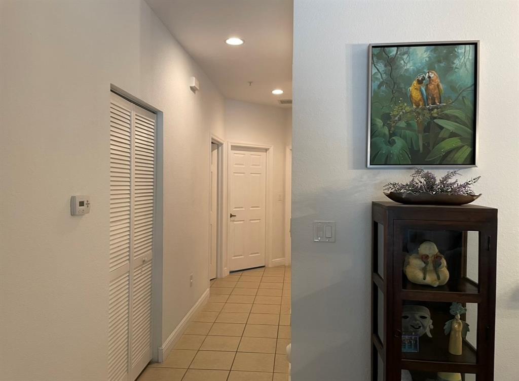 817 Southwest 147th Avenue, Unit 817 Pembroke Pines, FL 33027 - Photo 30 of 34 a view of a hallway with wooden floor and dining room