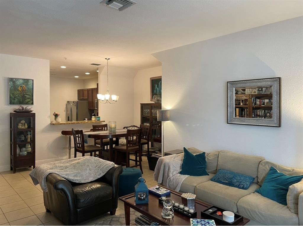 817 Southwest 147th Avenue, Unit 817 Pembroke Pines, FL 33027 - Photo 8 of 34 a living room with furniture kitchen view and a wooden floor