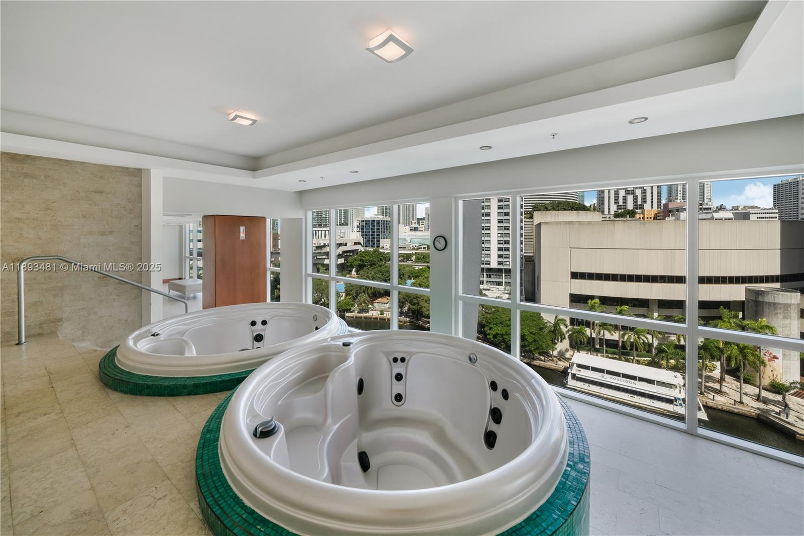 41 Southeast 5th Street, Unit 1709 Miami, FL 33131 - Photo 25 of 33 a bath tub sitting in a bathroom next to a window