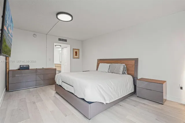 a spacious bedroom with a bed and a couch