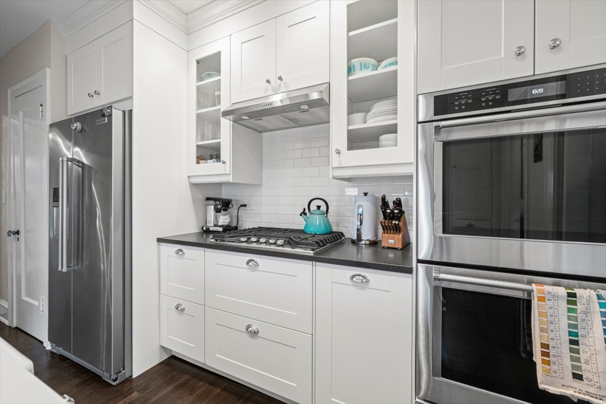 198 Wildwood Road Lake Forest, IL 60045 - Photo 16 of 37 a kitchen with stainless steel appliances granite countertop white cabinets and a refrigerator