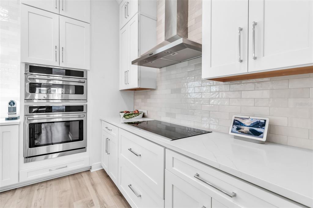 2554 Ruffing Court Sarasota, FL 34237 - Photo 13 of 32 a kitchen with granite countertop white cabinets and white appliances