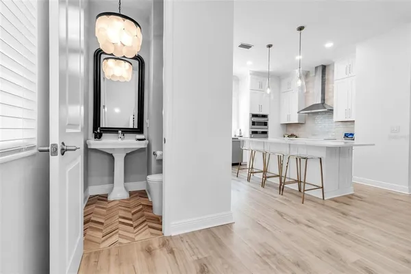 a view of kitchen with stainless steel appliances granite countertop a stove top oven a sink and a refrigerator