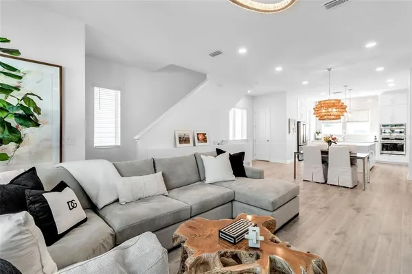 a living room with furniture and kitchen view