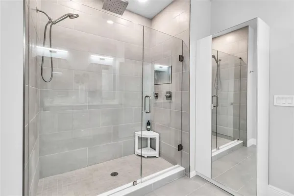 a bathroom with a glass shower door