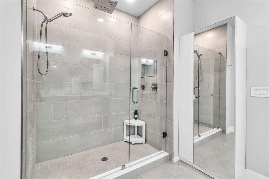 2554 Ruffing Court Sarasota, FL 34237 - Photo 24 of 32 a bathroom with a glass shower door