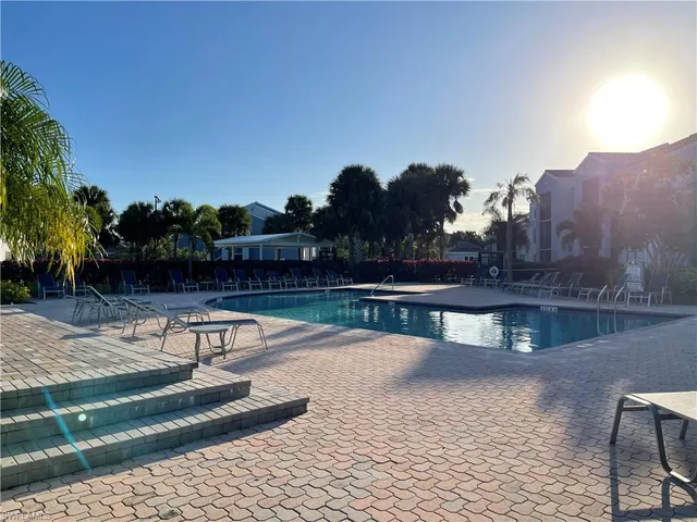 a view of swimming pool with a yard and plants