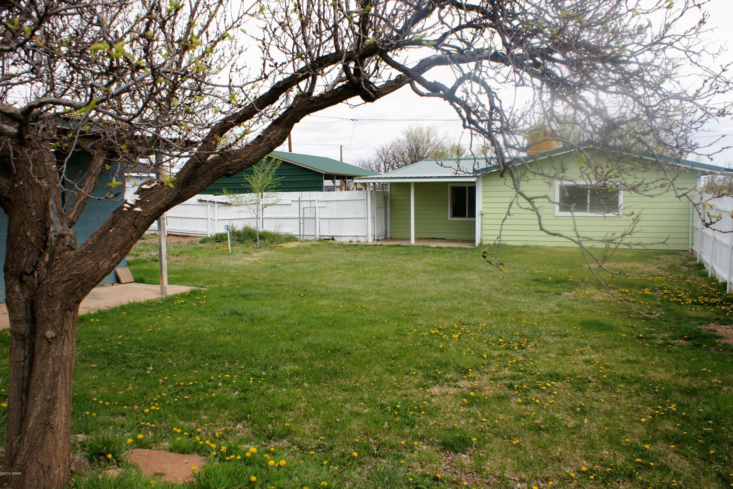 321 South 5th W Street Snowflake, AZ 85937 - Photo 4 of 32 a view of a yard in front of a house with large trees