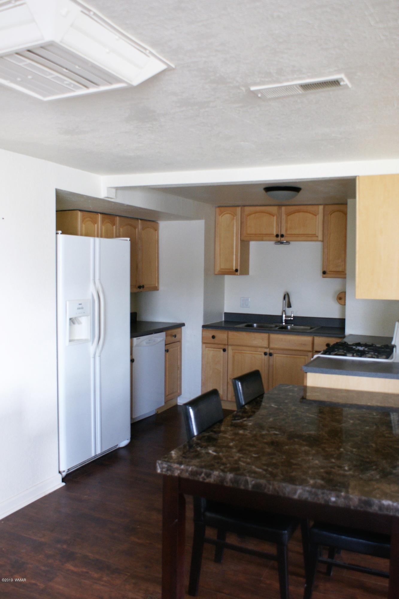 321 South 5th W Street Snowflake, AZ 85937 - Photo 6 of 32 a kitchen with stainless steel appliances granite countertop a sink refrigerator and cabinets