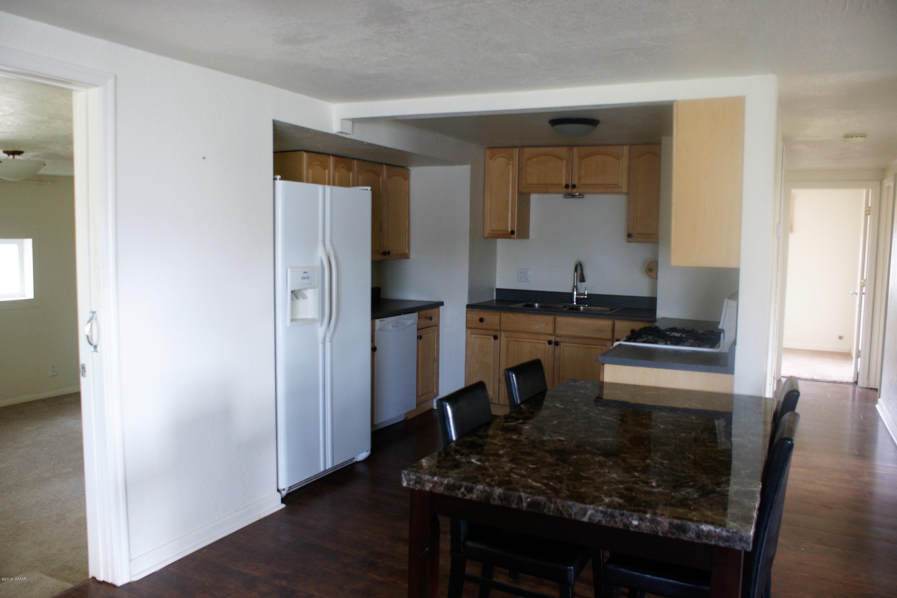 321 South 5th W Street Snowflake, AZ 85937 - Photo 7 of 32 a kitchen with a sink stove and refrigerator