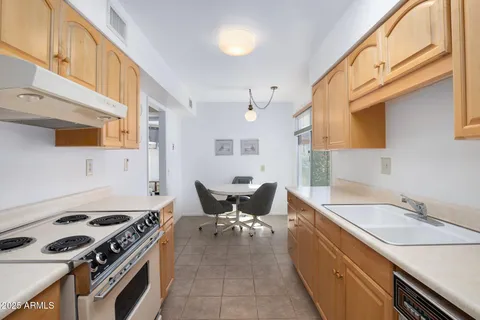 a kitchen with stainless steel appliances granite countertop a stove and a sink