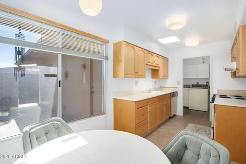 a kitchen with a sink refrigerator and cabinets