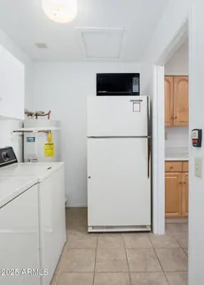a utility room with cabinets washer and dryer