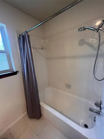 a bathroom with a shower and a bath tub