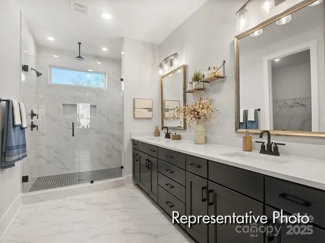 a bathroom with a sink shower and a mirror