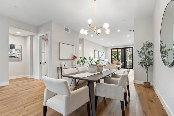 a view of a dining room with furniture window and wooden floor
