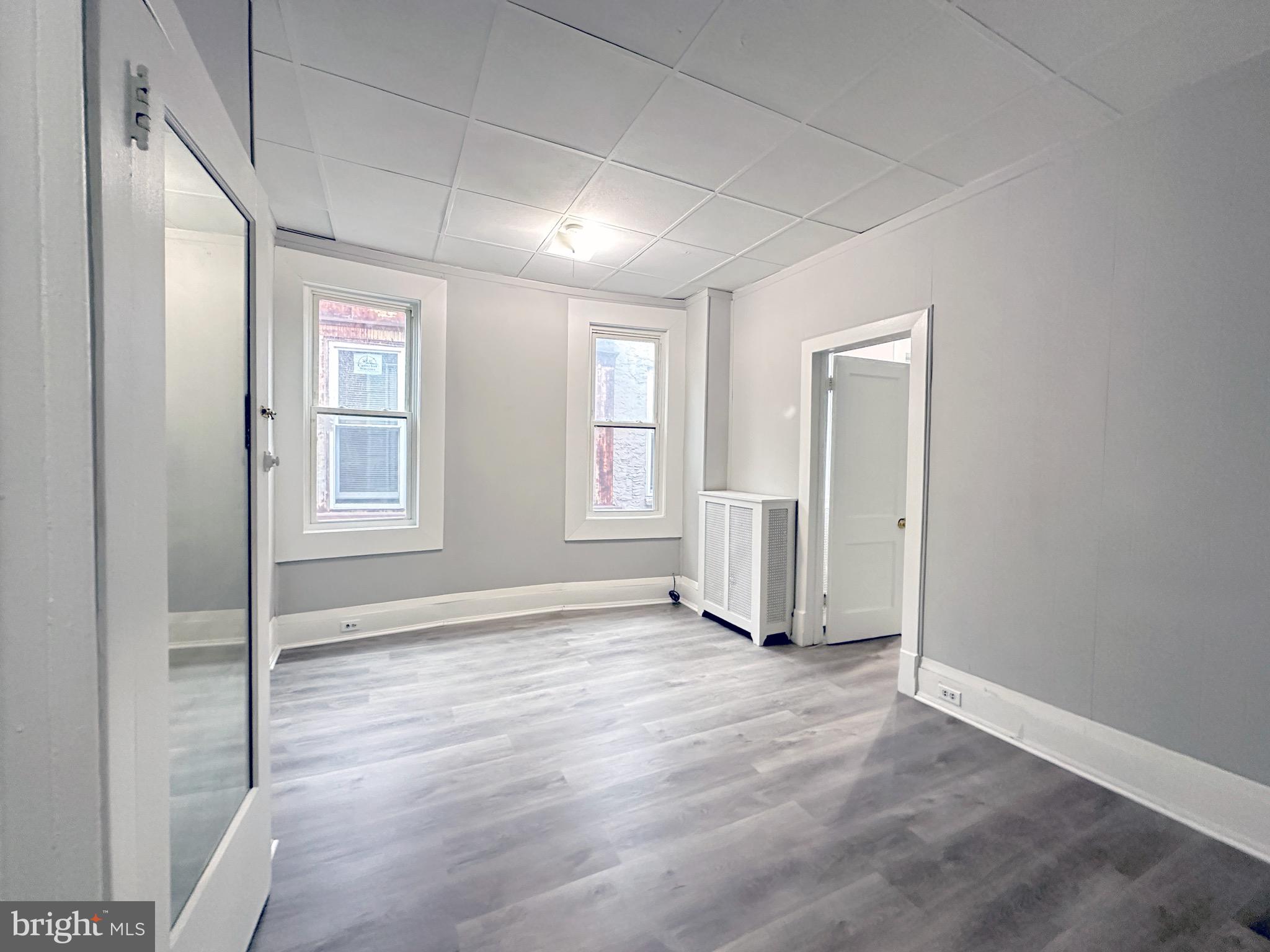 5424 Walnut Street Philadelphia, PA 19139 - Photo 5 of 7 an empty room with windows