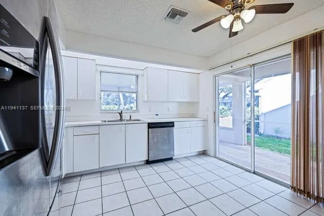 a kitchen with stainless steel appliances granite countertop a refrigerator sink and stove