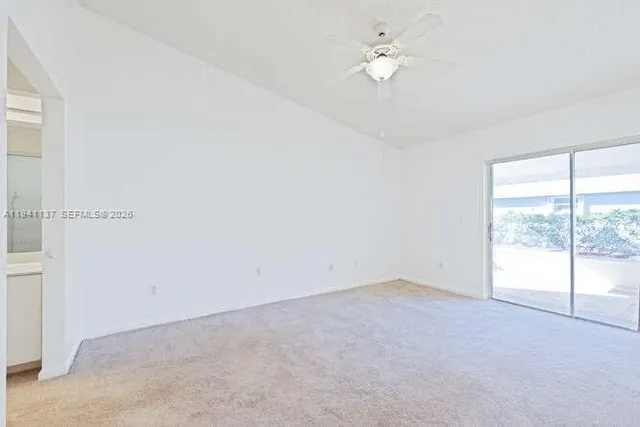 a view of an empty room and closet area