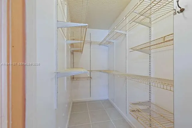 a view of a room with a ceiling fan and a window