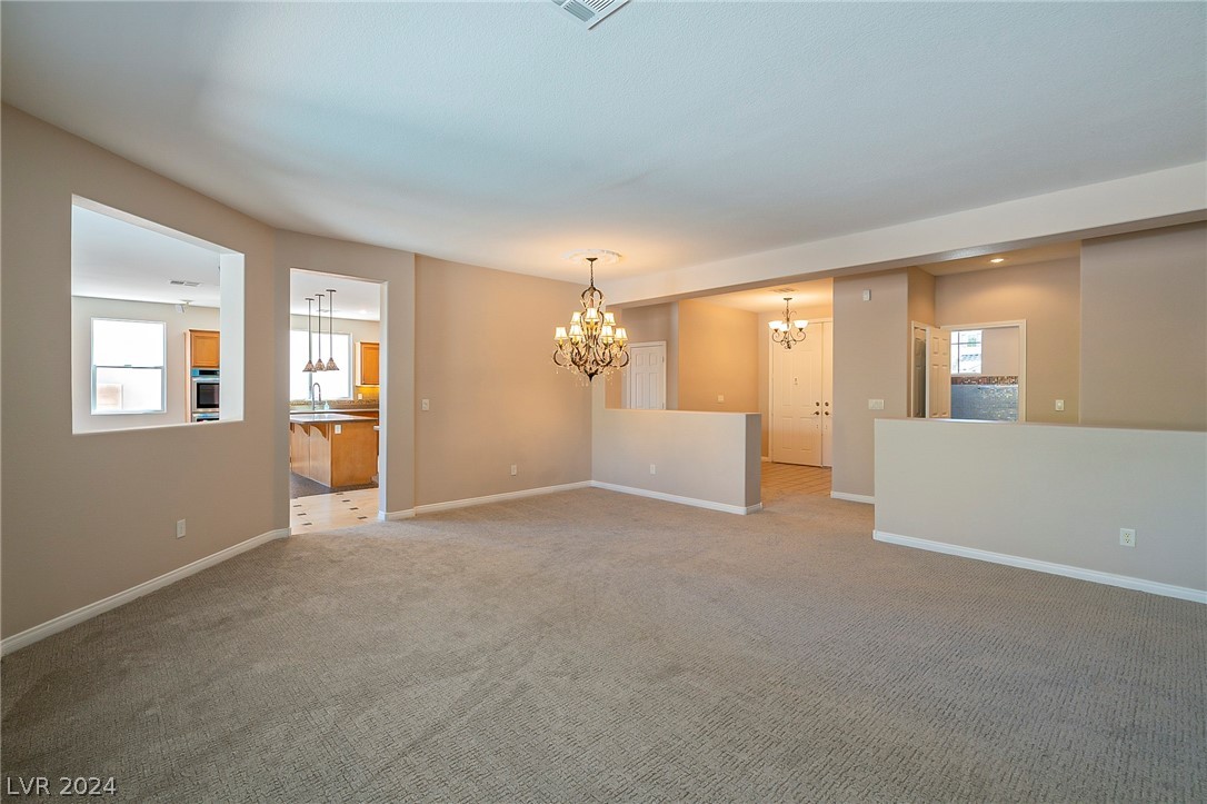 7858 Midnight Ride Street Las Vegas, NV 89131 - Photo 3 of 24 From the living area flow into the kitchen and the