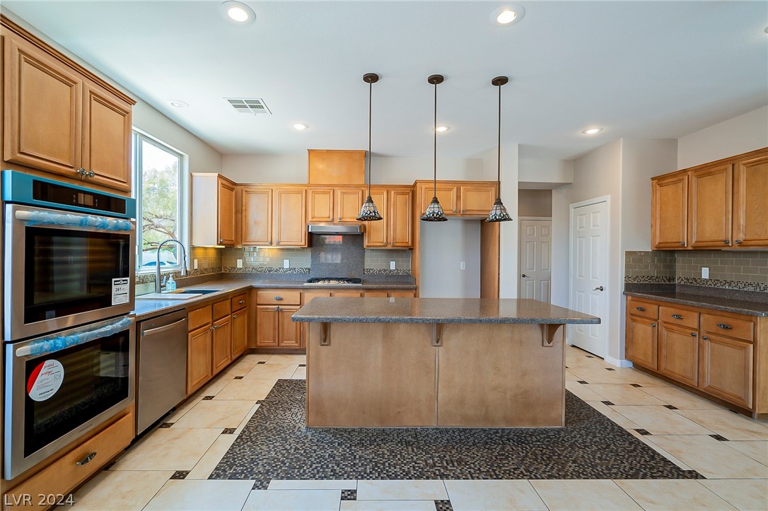 7858 Midnight Ride Street Las Vegas, NV 89131 - Photo 9 of 24 Large breakfast island, plenty of cabinets and a p