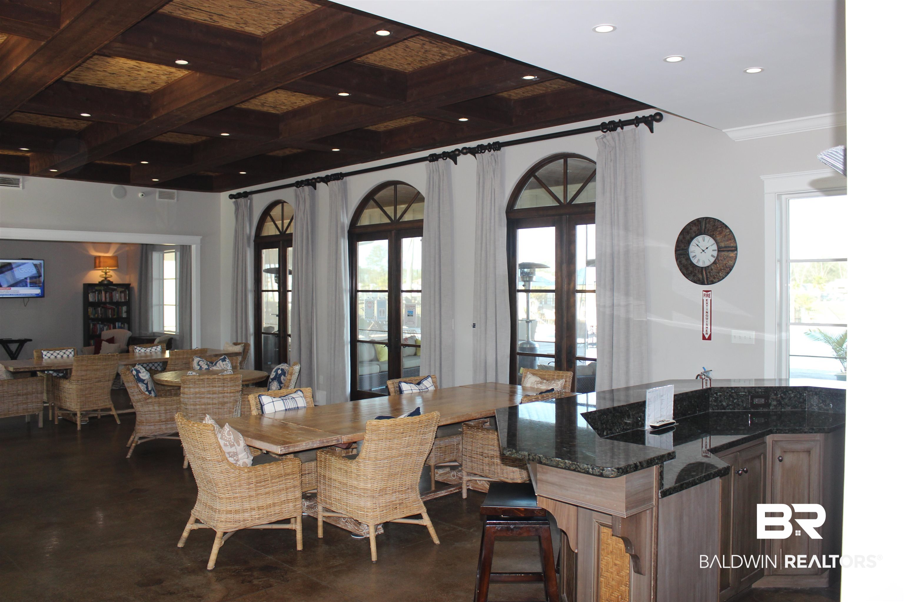 11869 Gateway Drive Elberta, AL 36530 - Photo 17 of 78 Dining room featuring recessed lighting, concrete flooring, beam ceiling, coffered ceiling, and french doors
