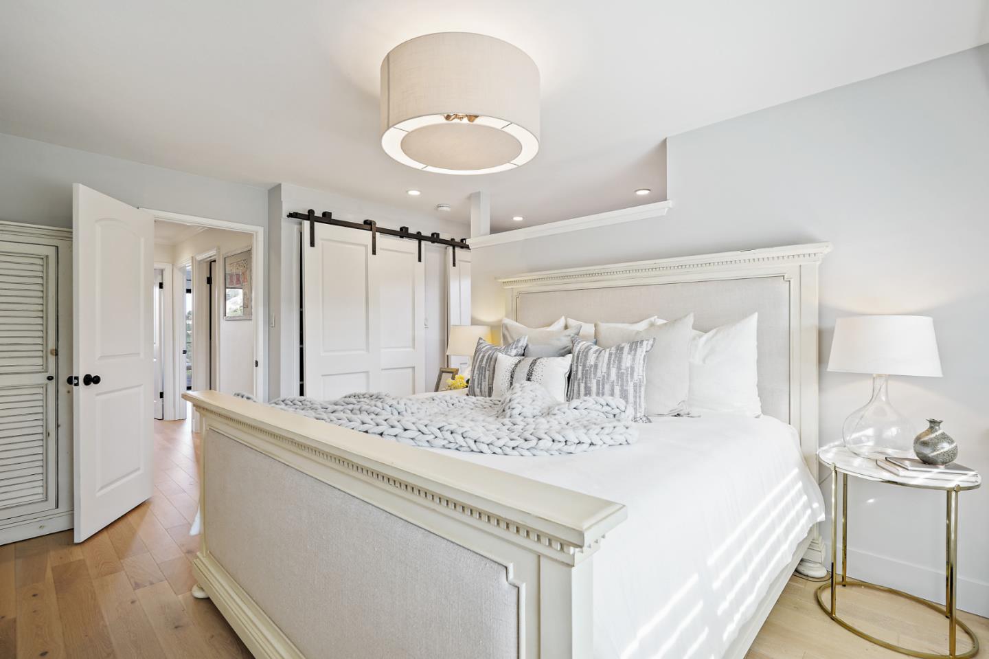 1914 Bishop Road Belmont, CA 94002 - Photo 33 of 79 a spacious bedroom with a bed and a chandelier