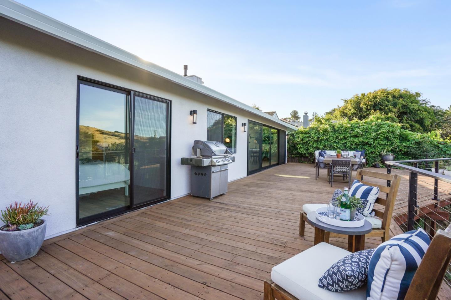 1914 Bishop Road Belmont, CA 94002 - Photo 53 of 79 a view of a patio with couches potted plants and wooden floor