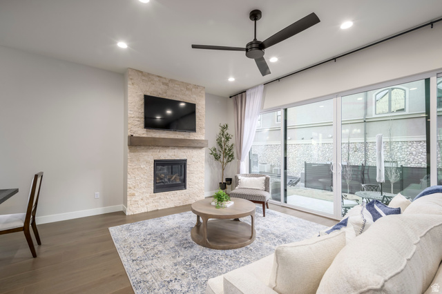 250 South Main Street, Unit 9 Alpine, UT 84004 - Photo 12 of 34 Living area featuring a stone fireplace, a ceiling fan, wood finished floors, and recessed lighting